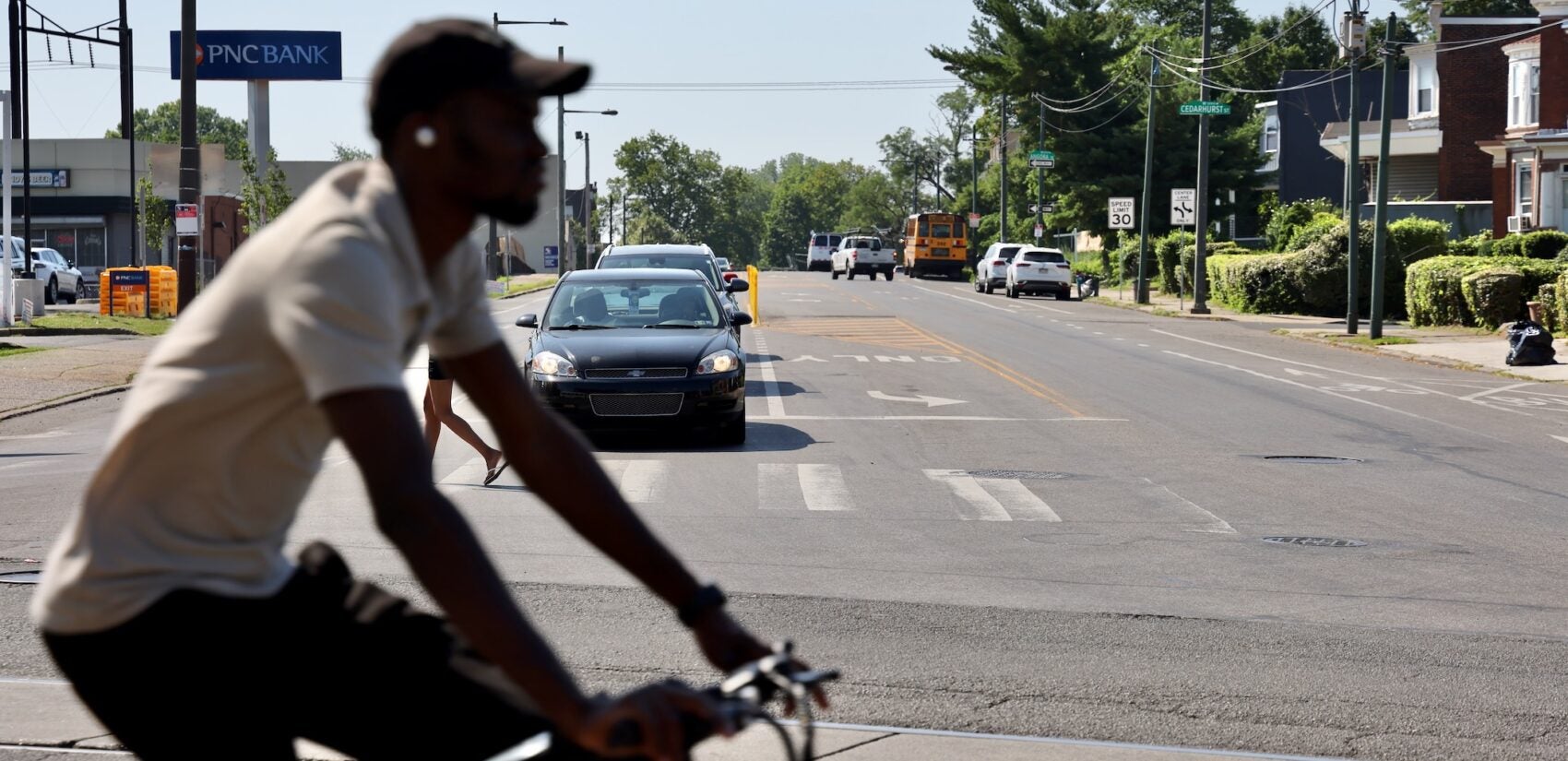 a cyclist crosses the intersection of Baltimore Avenue, Cobbs Creek Parkway and 58th Street