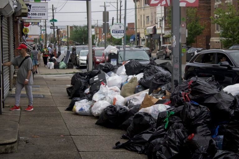 trash piled up on the street at Broad Street and Snyder Avenue in Philadelphia