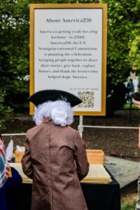 a person in a wig at an America250 event