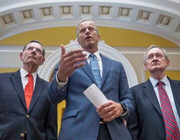 Senate Majority Leader John Thune, R-S.D., is flanked by Sen. John Barrasso, R-Wyo., the GOP whip, left, and Finance Committee Chairman Mike Crapo, R-Idaho, speaks to reporters after passage of the budget reconciliation package of President Donald Trump's signature bill of big tax breaks and spending cuts, at the Capitol in Washington, Tuesday, July 1, 2025. (AP Photo/J. Scott Applewhite)