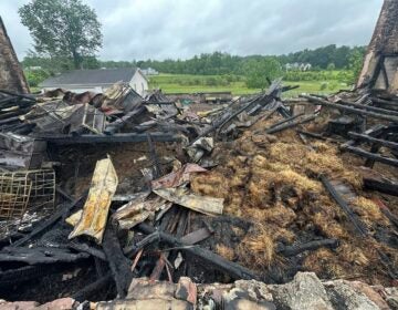 A heavily damaged barn after a fire