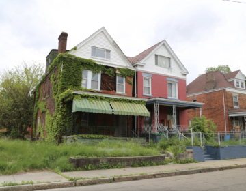 Blighted property with an overgrown lawn